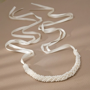 Elegant bridal belt with white pearls and long satin ribbons for weddings and parties