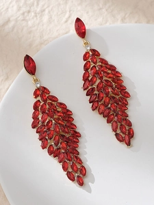 Detail view of red marquise gemstone leaf drop earrings with elegant gold-tone setting