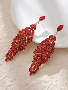 Detailed macro view of cascading red crystal petal tassel earrings with gold setting