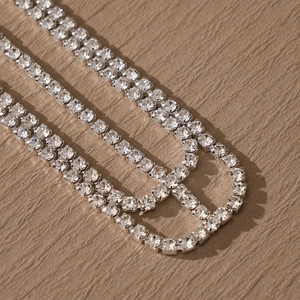 Close-up of sparkling rhinestone tassel hair chain with silver plated tennis chain detail
