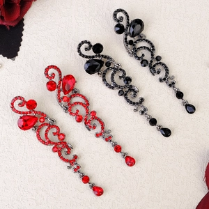 Detail of vintage teardrop earrings with crystals in black and red for bridal party