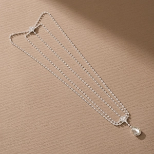 Detail of silver multilayer rhinestone head chain with a teardrop crystal pendant