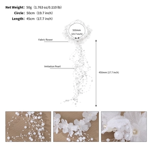Detailed view of white fabric flowers and layered imitation pearl tassels on bridal headband