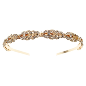 Detailed close-up of golden bridal headband with rhinestone feathers and elegant crystals