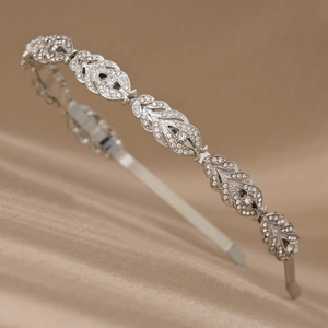 Detail of silver leaf tiara headband with shimmering rhinestones on champagne velvet
