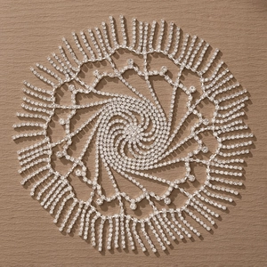 Detail of silver rhinestone headpiece with layered spiral design and hanging fringe