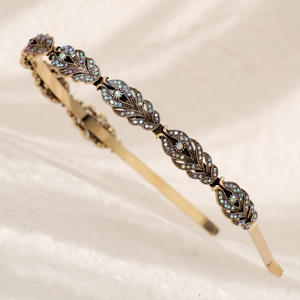 Elegant gold bridal headband with hollow leaf design and iridescent rhinestones
