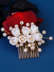 Detail showing white tulip ceramic flowers with pink crystal beads on a gold bridal comb