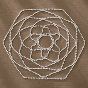 Detailed close-up of multilayer silver rhinestone floral headpiece on leather