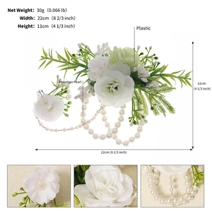 Detail of white artificial rose bridal corsage with synthetic pearls and green leaves