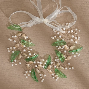 Elegant gold leaf bridal headband with green acrylic leaves and pearls on soft ribbon