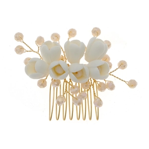 Elegant bridal hair comb with white ceramic flowers and champagne pearl beads in gold finish