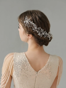 Close-up of bridal hair comb featuring silver vines and sparkling marquise crystals