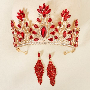 Detailed view of luxury red rhinestone crown and matching long leaf earrings for weddings