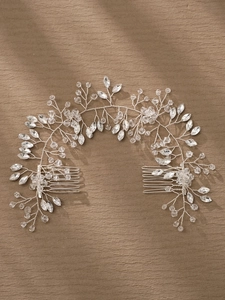 Macro view of crystal leaf accents and silver wire on this handmade bridal hair comb set