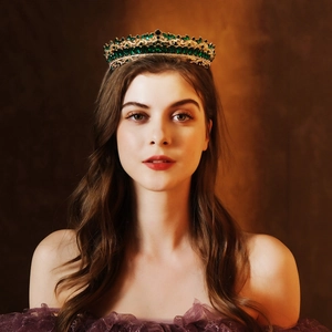 Detail of luxury bridal crown with emerald green rhinestones and gold metal frame