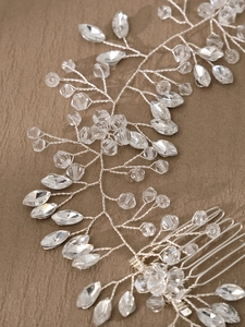 Macro shot of silver bridal hair comb with marquise crystals and handmade wire details