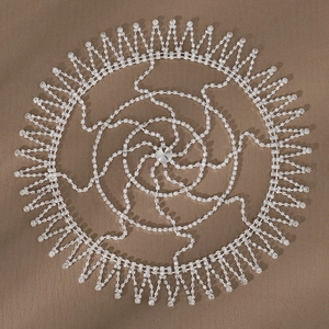 Close-up of vintage rhinestones of vintage rhinestone tassel hair chain with radiant sunburst design