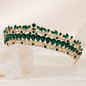 Detail of emerald green teardrop crystals and gold metal setting on baroque bridal crown