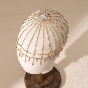 Detailed top view of gold bridal hair chain featuring central rhinestone and fringe