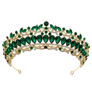 Detailed close-up of a vintage golden bridal tiara with green teardrop rhinestones