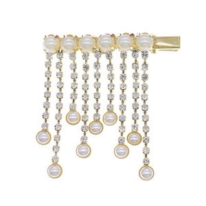 Detail of gold fringe hair clip with white pearls and cascading rhinestone tassels
