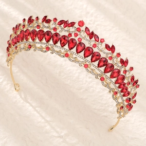 Close-up of luxury gold bridal crown with red pear-cut crystals and fine rhinestones
