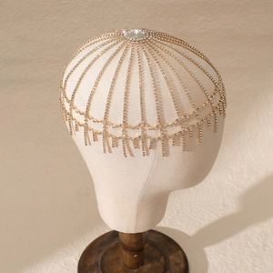 Macro detail of vintage bridal rhinestone head chain with gold mesh and crystal tassels