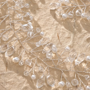 Macro detail of handmade silver bridal hair vine with white pearls and clear crystals