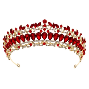 Macro shot of Baroque gold tiara with red pear-cut crystals and intricate rhinestones