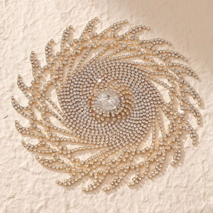 Luxurious gold radiant sunburst hair chain with rhinestones and central crystal detail