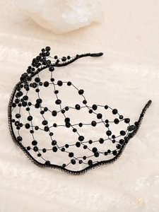 Close-up of handmade black woven beaded headband with crystals and vintage mesh details