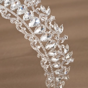 Detailed close-up showing the intricate marquis and teardrop rhinestones on silver crown