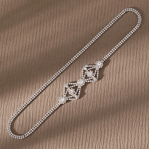 Detail of silver hair chain with sparkling rhinestones and floral geometric patterns