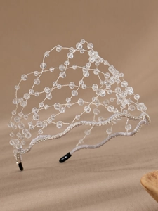 Detail of silver crystal beaded headband with hand-woven rhinestones and grey fabric base