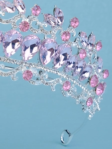 Close-up of silver bridal crown with pink marquise rhinestones and intricate crystals