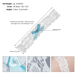 Detailed view of white lace bridal garter with blue satin bow and pearl accent