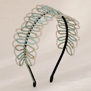 Handmade beaded headband featuring light blue and champagne glass crystals in leaf design