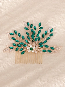 Detail of bridal hair comb with green marquise crystals and gold alloy leaves