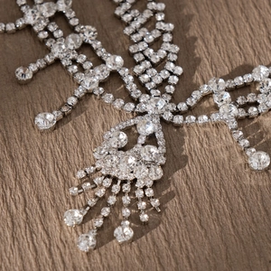 Macro view of silver fringe hair chain with cascading rhinestones for party styling