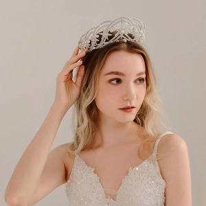 Elegant silver star crown with pearls and rhinestones on model for weddings
