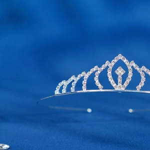 Close-up of elegant silver rhinestone crown with symmetrical geometric patterns for girls