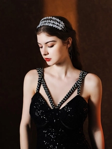 Detail of silver layered headband with rhinestones and butterfly motif worn by a model