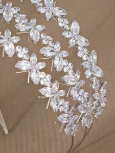 Macro shot of silver zircon headband with detailed butterfly and floral crystal motifs