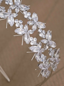 Macro detail of multilayer zircon headband showing intricate silver floral stone setting