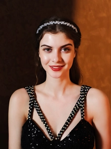 Close-up detail of silver headband with sparkling cubic zirconia flowers on model