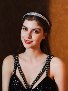 Close-up of sparkling multilayer zircon headband worn with elegant black sequin dress