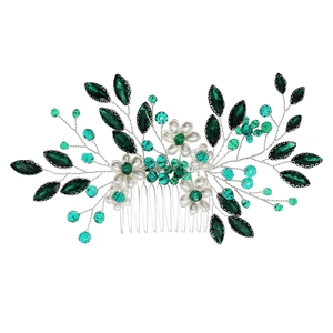 Elegant bridal hair comb with green crystals, white pearls, and silver floral branch details
