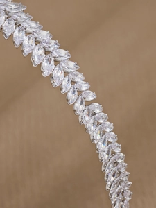 Detailed close-up of marquise-cut zircons set in a silver multi-layer headband
