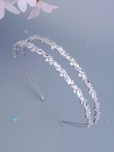 Detail of double-layer silver headband featuring marquise-cut zircons and crystal leaf pattern